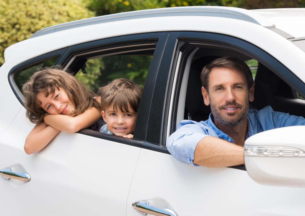 Dad with children in a white car