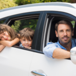 Dad with children in a white car