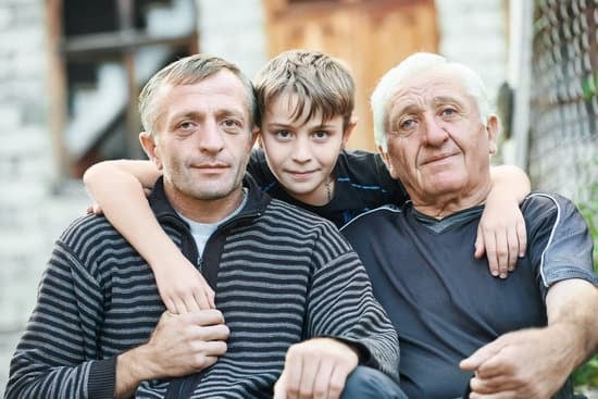 As boy with his father and grandfather hugging.
